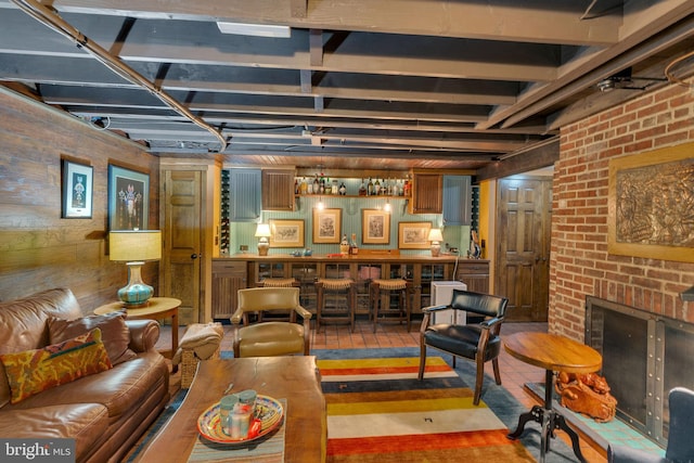 living room with indoor bar and a brick fireplace