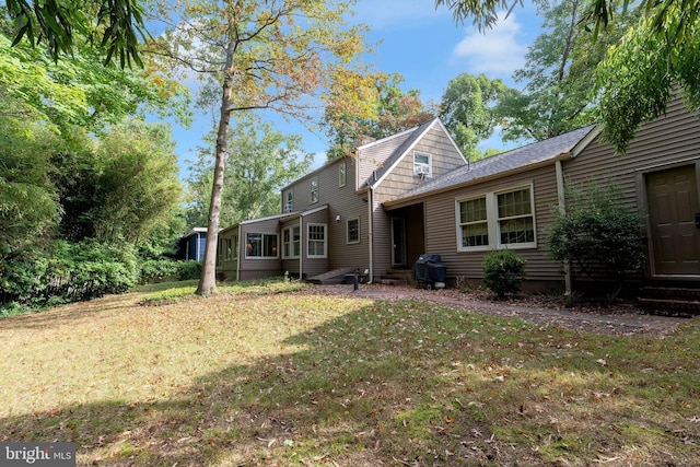 back of property featuring a yard