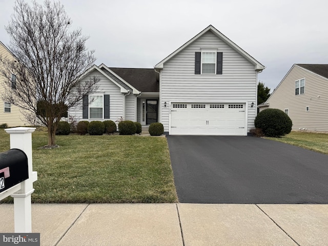 view of property with a garage and a front yard