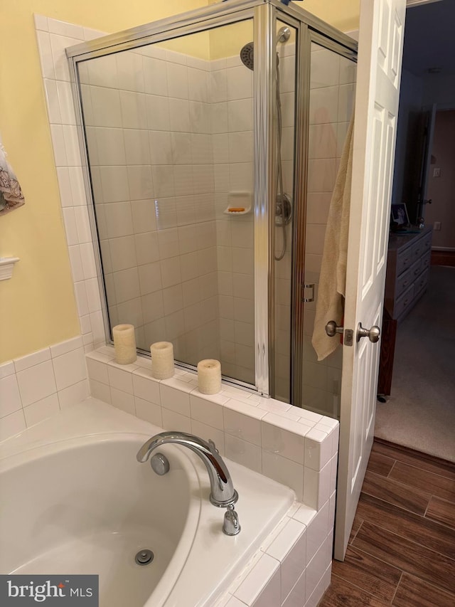 bathroom featuring shower with separate bathtub