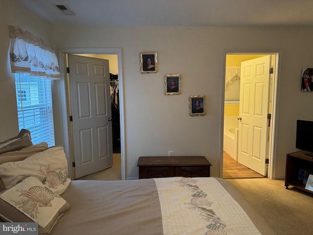 bedroom with light colored carpet and a closet