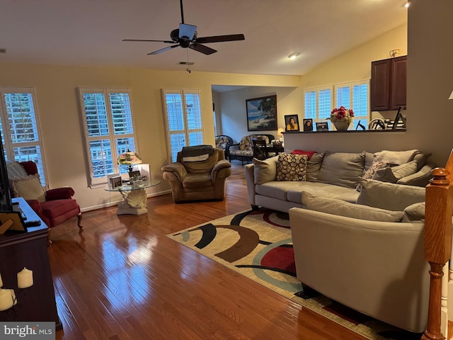 living room featuring hardwood / wood-style floors, vaulted ceiling, and ceiling fan