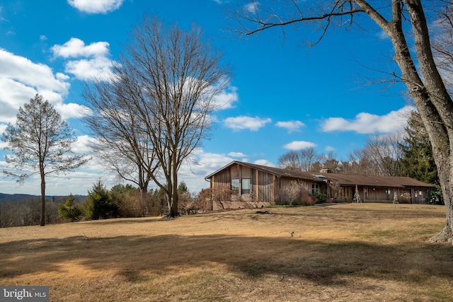 view of side of property with a yard