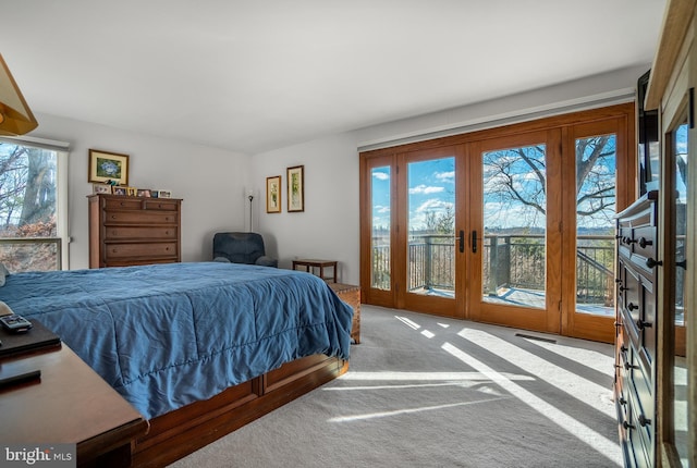 bedroom featuring access to exterior, visible vents, light colored carpet, and french doors