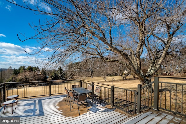 wooden terrace with outdoor dining space