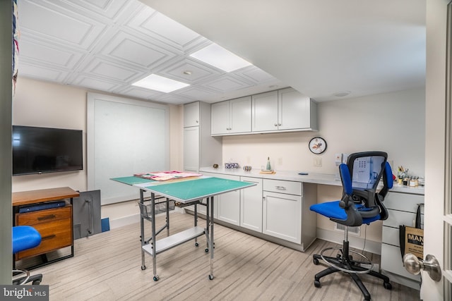 office space featuring built in desk, an ornate ceiling, light wood-style flooring, and baseboards