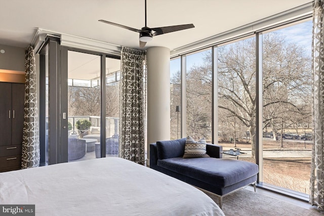 bedroom featuring ceiling fan, floor to ceiling windows, and access to exterior