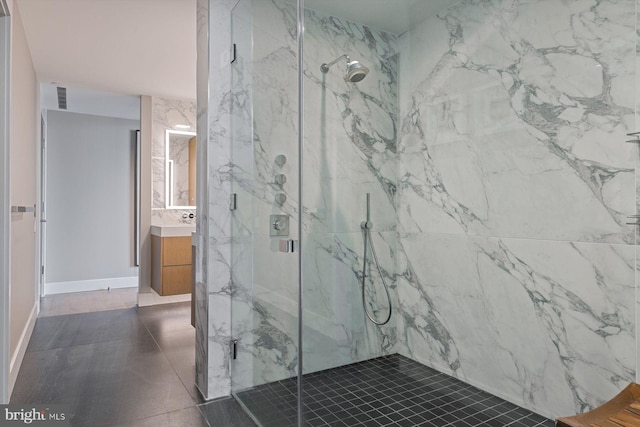 bathroom featuring a shower with door and vanity