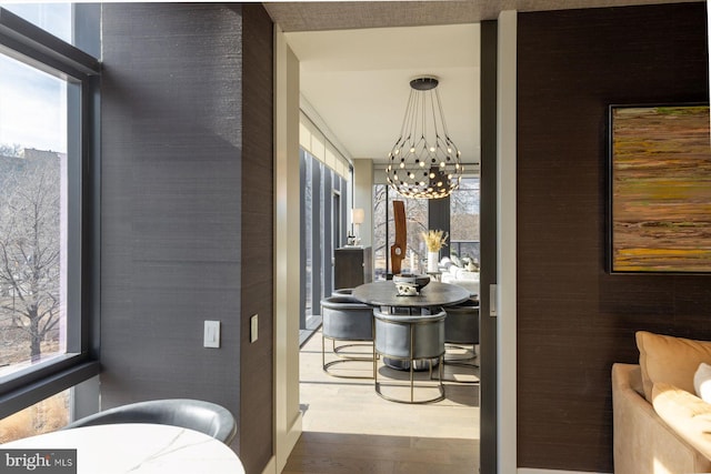 bathroom featuring hardwood / wood-style flooring, a healthy amount of sunlight, and a notable chandelier