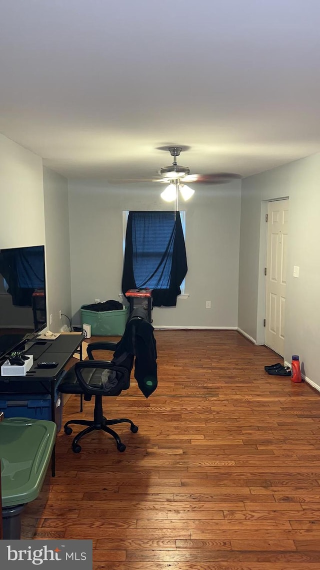 home office featuring hardwood / wood-style floors and ceiling fan