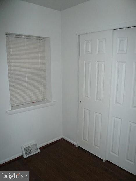 unfurnished room with dark hardwood / wood-style floors