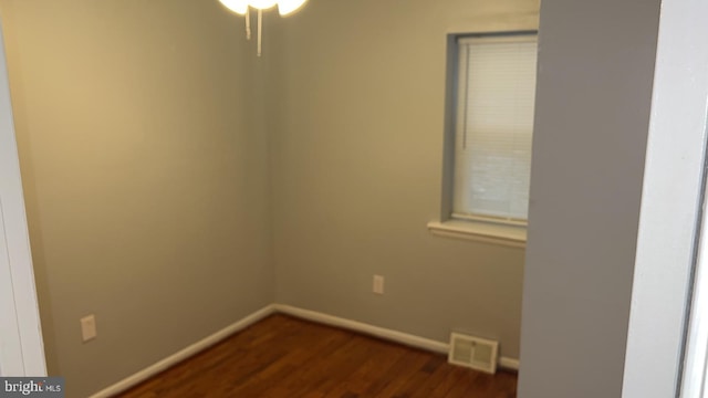 spare room with dark hardwood / wood-style floors