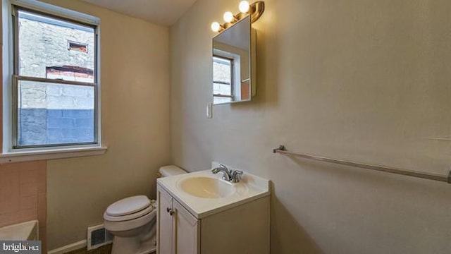 bathroom featuring vanity and toilet