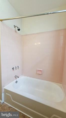 bathroom with tile patterned floors and tiled shower / bath combo