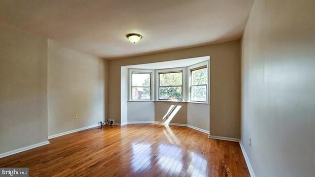 unfurnished room featuring hardwood / wood-style floors