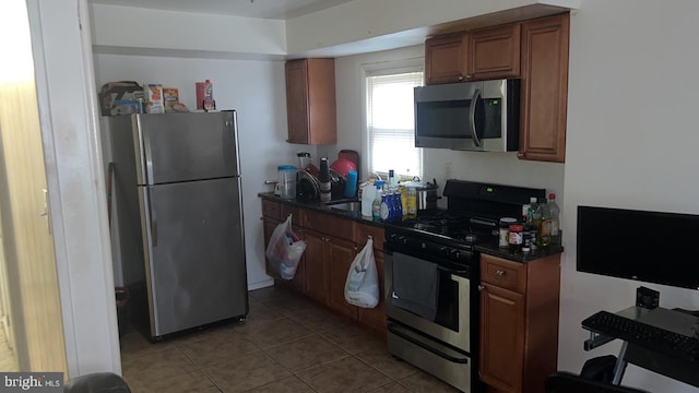 kitchen featuring stainless steel appliances and light tile patterned floors