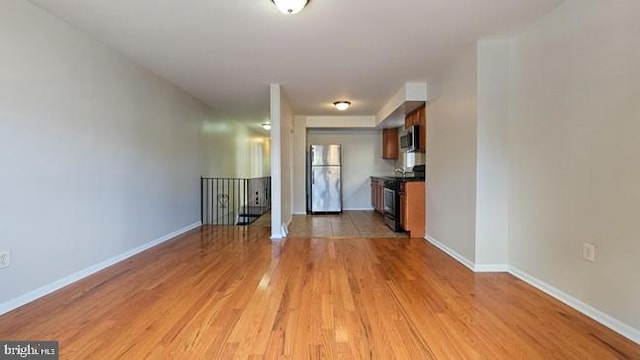 unfurnished living room with light hardwood / wood-style flooring