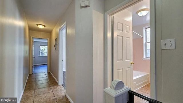 corridor featuring light tile patterned floors