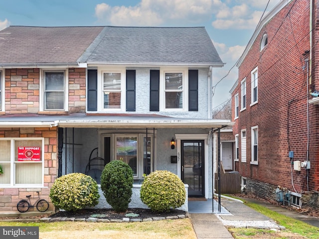 townhome / multi-family property featuring covered porch