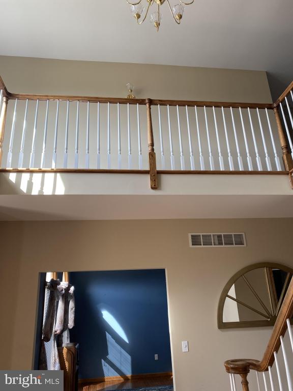 stairway with a high ceiling and a chandelier