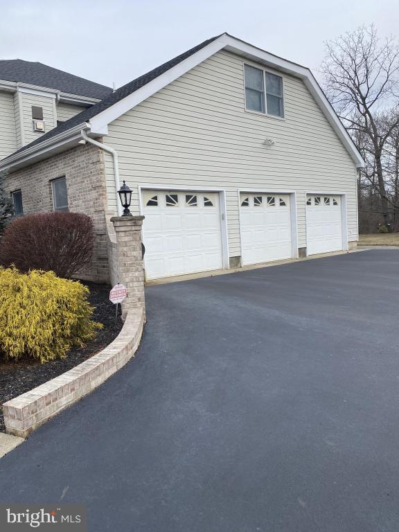 view of side of home featuring a garage