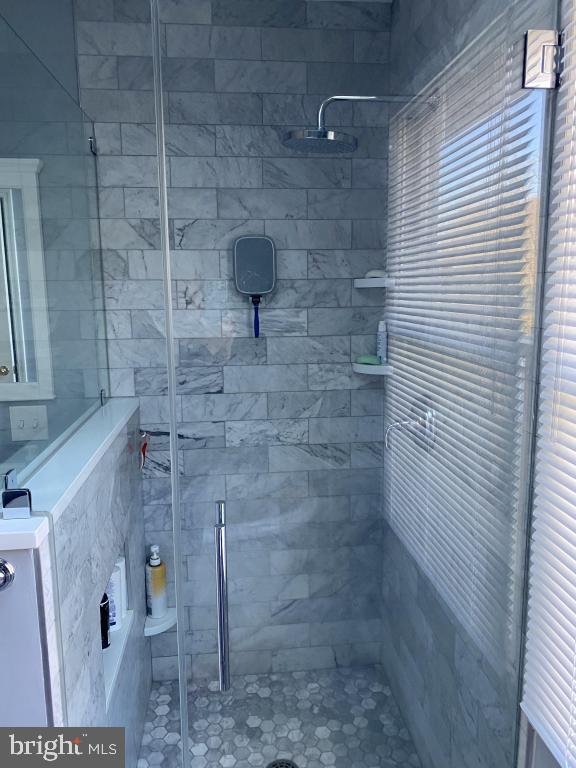 bathroom with a tile shower