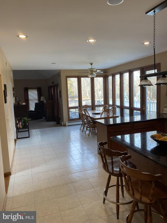 dining space with light tile patterned flooring and ceiling fan