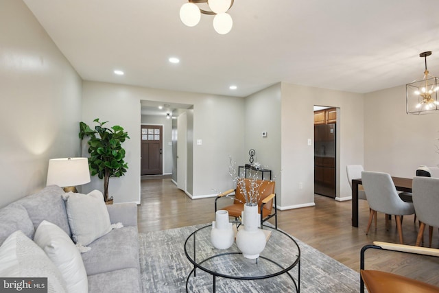 living room featuring a chandelier and wood-type flooring