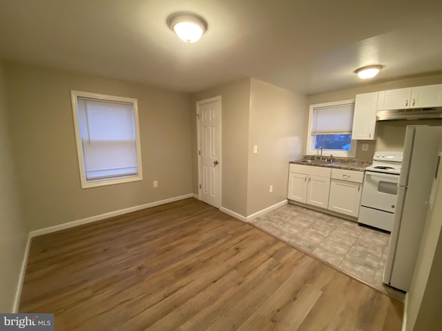 kitchen featuring sink, white appliances, white cabinets, and light wood-type flooring