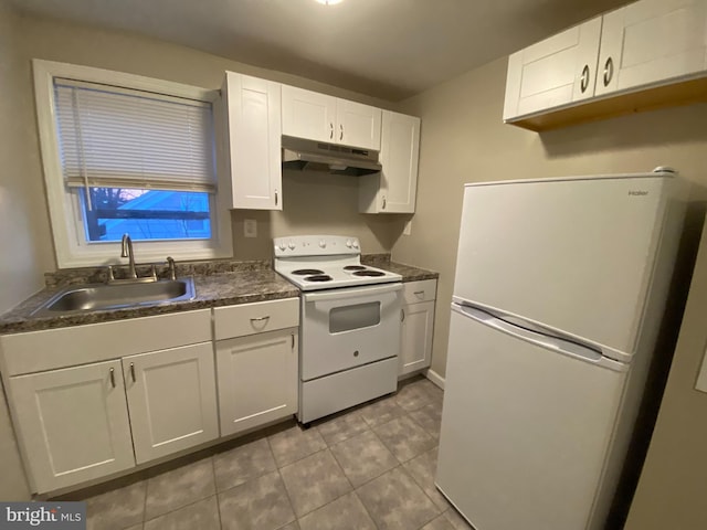 kitchen with white appliances, sink, and white cabinets