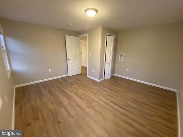 unfurnished bedroom with hardwood / wood-style flooring