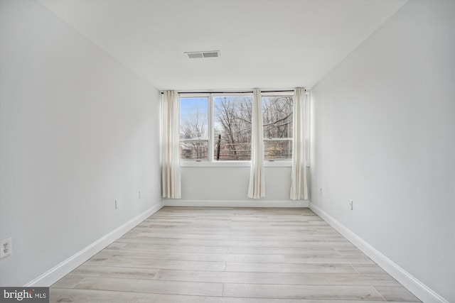 empty room with light hardwood / wood-style floors