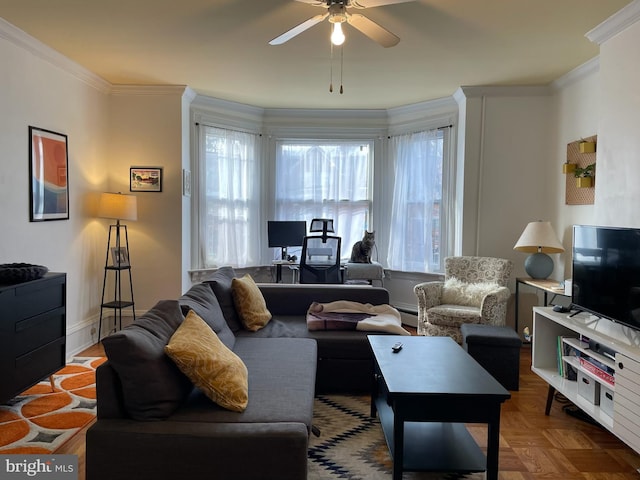 living room featuring a wealth of natural light, crown molding, and ceiling fan