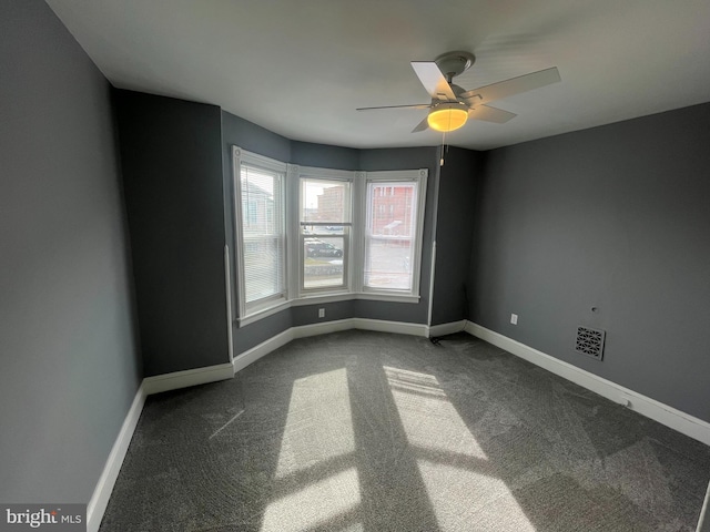 empty room with carpet floors and ceiling fan