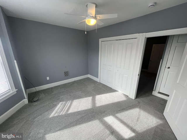 unfurnished bedroom with ceiling fan and carpet