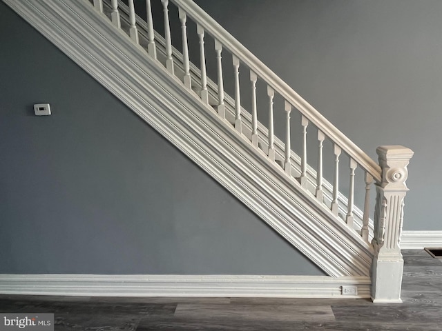 stairs featuring hardwood / wood-style floors