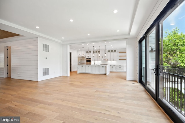 unfurnished living room featuring recessed lighting, visible vents, and light wood-style flooring