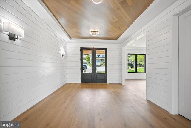 entrance foyer featuring wood ceiling, french doors, and wood finished floors