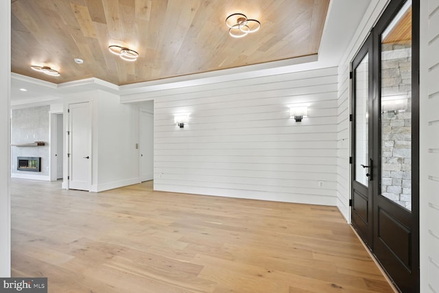 entrance foyer with wooden ceiling, a fireplace, and light wood finished floors