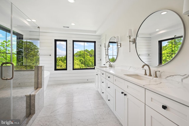 bathroom with double vanity, visible vents, a sink, and recessed lighting