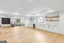 bar featuring light wood-style floors, a tray ceiling, and recessed lighting