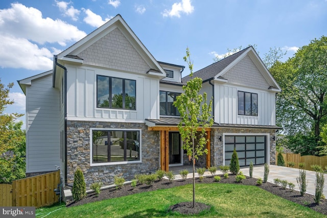 view of front of property featuring driveway, board and batten siding, and fence