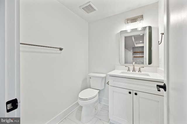 half bath with marble finish floor, visible vents, toilet, vanity, and baseboards