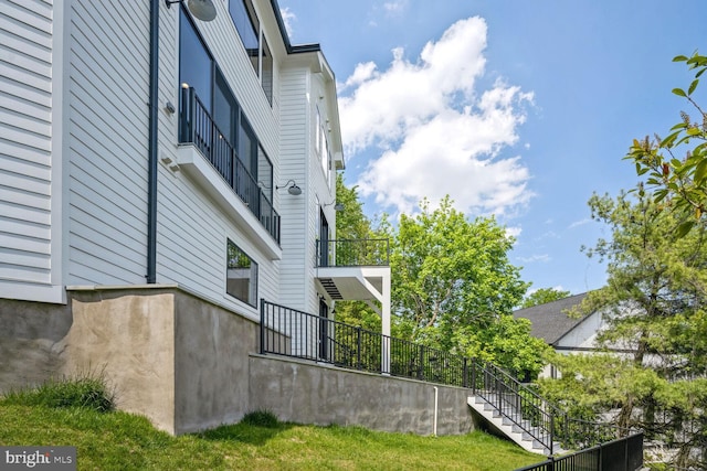 view of side of property featuring stairs