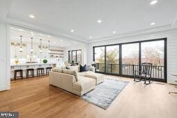 living room with recessed lighting and wood finished floors