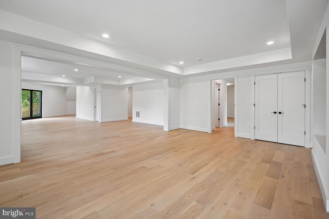 below grade area with baseboards, light wood finished floors, and recessed lighting