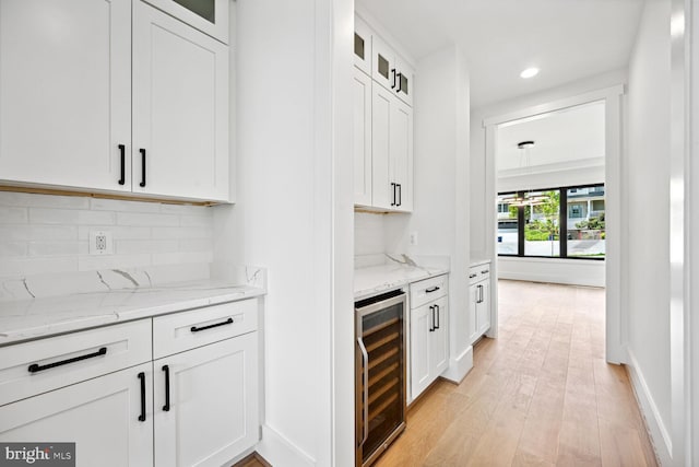 bar featuring tasteful backsplash, baseboards, wine cooler, light wood-style floors, and recessed lighting