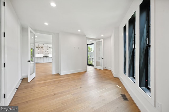 empty room with french doors, recessed lighting, visible vents, light wood-style floors, and baseboards