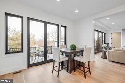 dining room with light wood-style flooring, baseboards, and recessed lighting