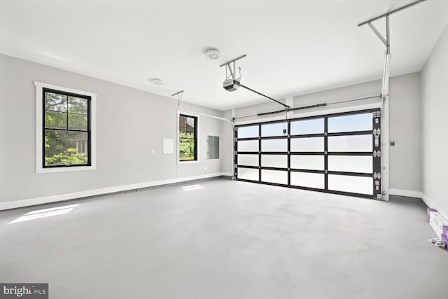 garage with electric panel, baseboards, and a garage door opener